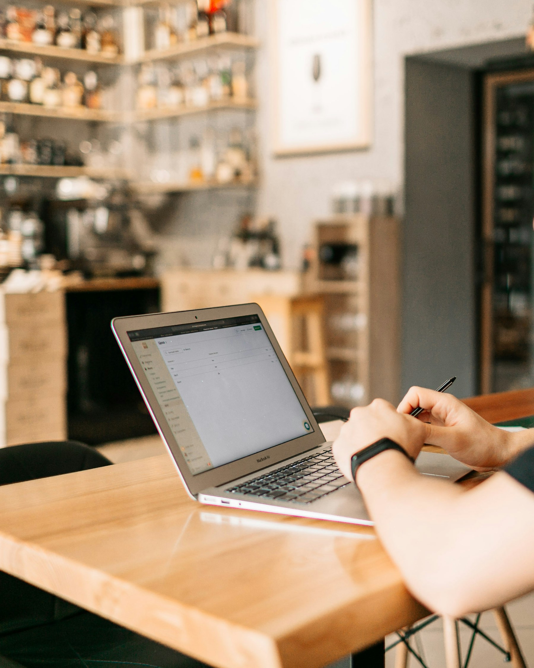 Restaurant manager working on a laptop at a cafe table